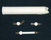 The image shows the Cautery Kit - cordless high heat with a white cylindrical device featuring a side button, displayed above three interchangeable metal-pronged tips on a dark surface.
