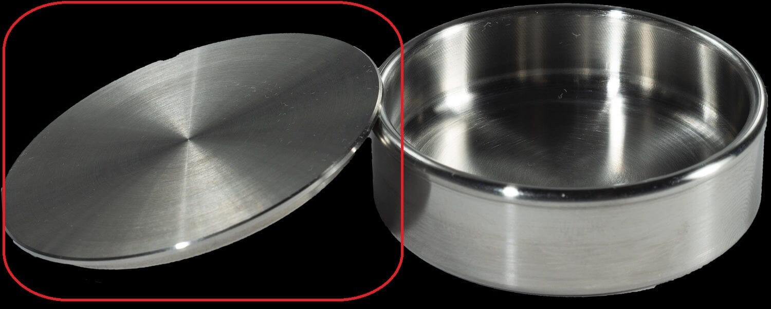 The McBio Bone Graft Container Lid – Stainless Steel is shown with its round, silver-colored container and brushed finish for spill prevention, both placed on a black background.