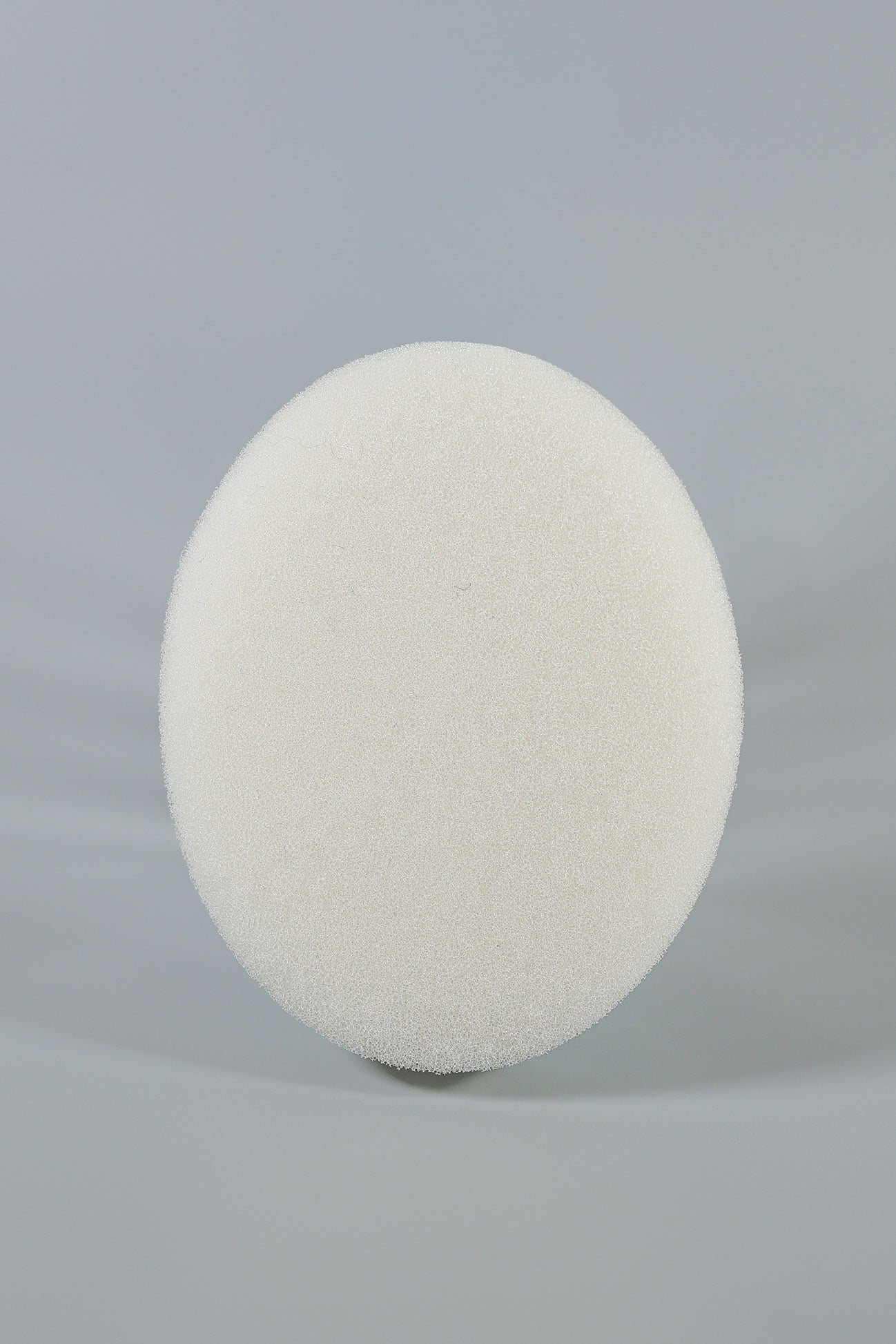 A round, white C-Sponge Regular Polyurethane Surgical Throat Pack by Xemax stands upright against a plain, light grey background.
