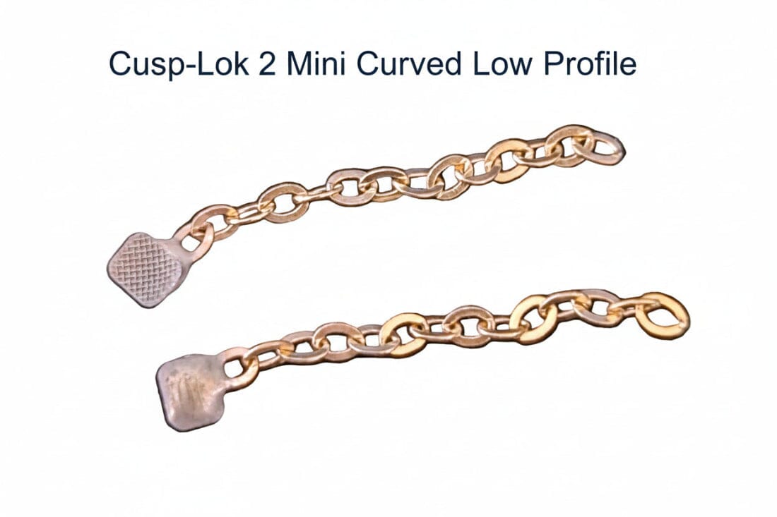 Two 1" 14K gold Cusp-Lok 2 bracket-based impacted cuspid traction chains by Xemax, each with a textured flat end, are shown on a white background. The text above reads: "Cusp-Lok 2 | Bracket-Based Impacted Cuspid Traction.