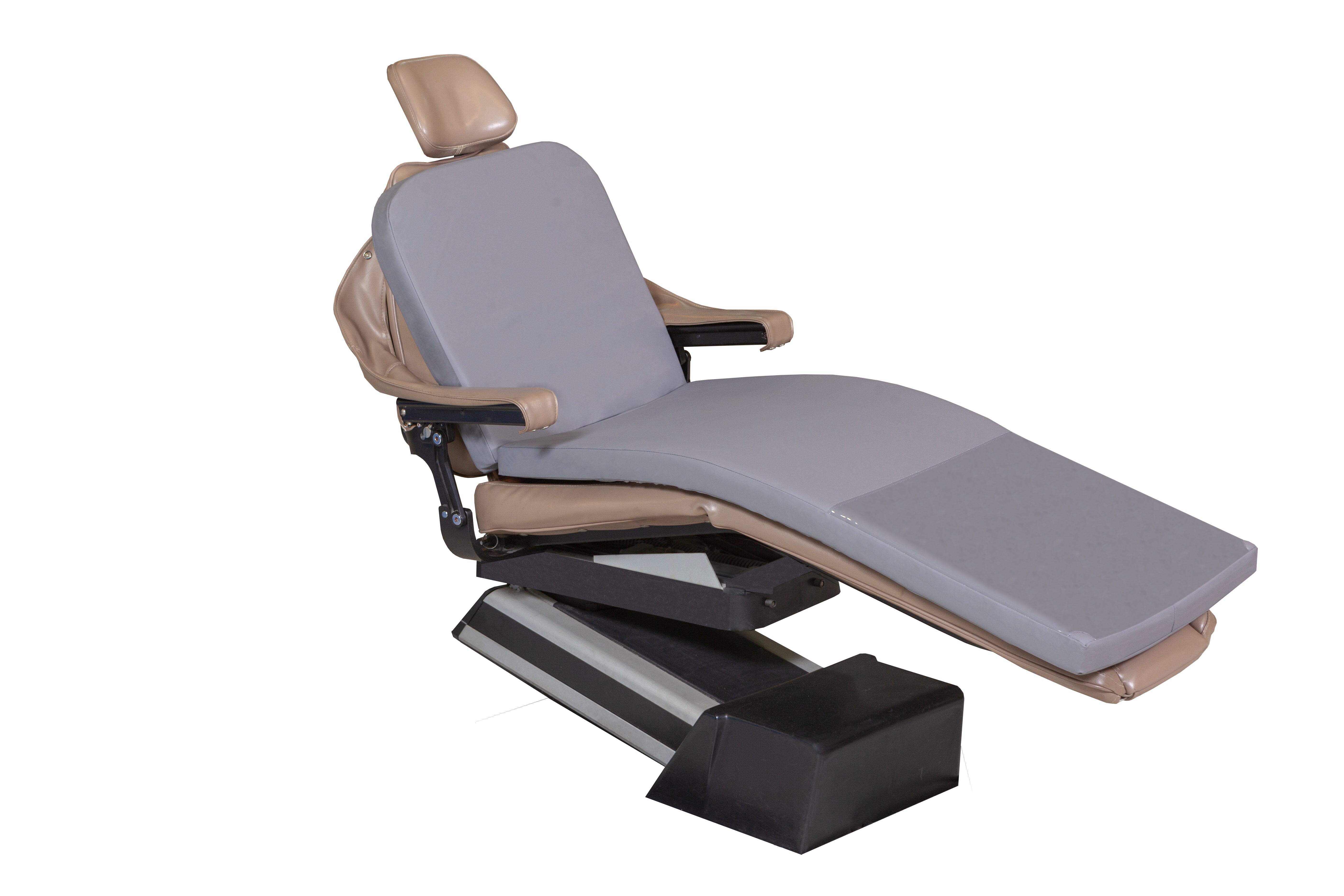 The Mediposture Memory Overlay Pad, a full-length memory foam dental chair cushion by Mediposture, is shown on a modern reclining dental chair with padded armrests and headrest in light brown and gray, isolated on a white background.