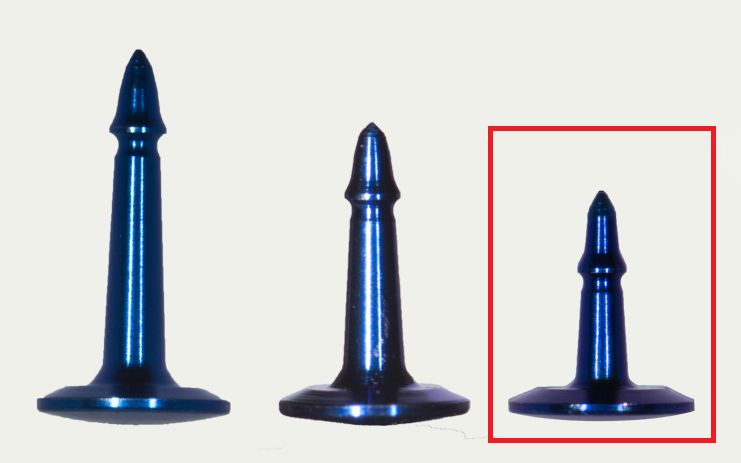 Three metallic blue SuperTack Fixation Tacks – Titanium GBR (3mm, 4mm, 5mm) by McBio stand upright on a light background; the smallest tack, outlined in red at the image’s right, resembles those used in guided bone regeneration.