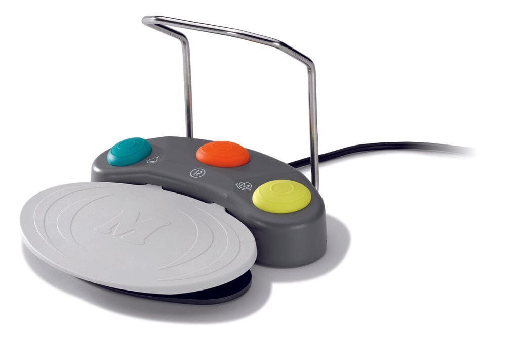 A gray W&H Foot Control for Implant Motors and Surgical Systems with three colorful buttons, a wired connection, a raised metal guide, and a large white pedal in front.