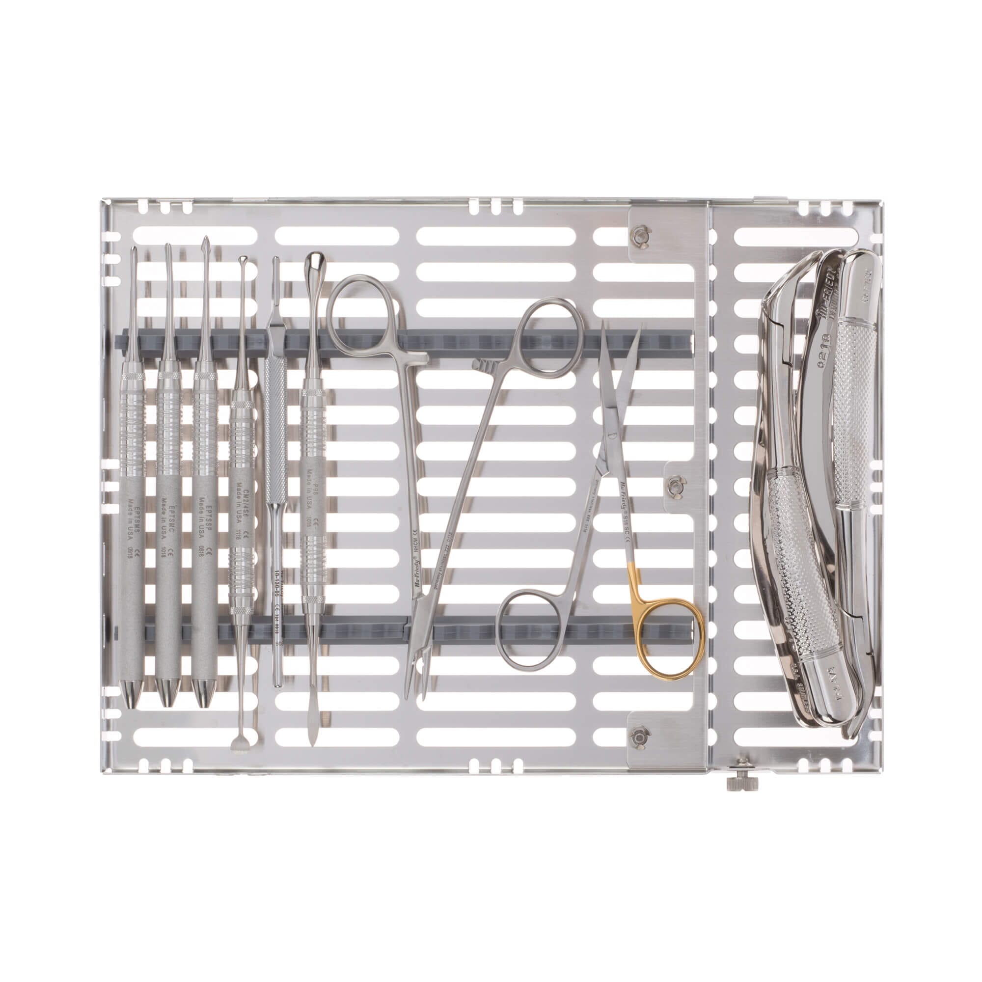 The Hu-Friedy Atraumatic Extraction Kit includes stainless steel scissors, forceps, and clamps, all organized in a metal tray with slotted openings—ideal for precise tooth extraction procedures.