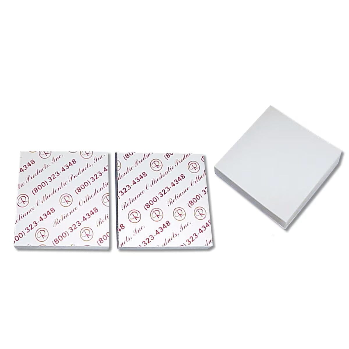 Three Reliance Disposable Mixing Pads are shown: two with Reliance-branded backing featuring red text and logos, and one with the backing removed, revealing a plain white sticky surface.