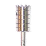 A close-up of a Dentech Bone Trephine, a cylindrical metallic drill bit by Dentech with a toothed edge and horizontal grooves, designed for cutting holes in hard materials during implant surgery.
