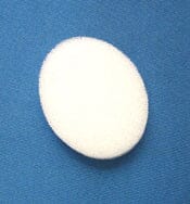 The Xemax C-Sponge Pedo Pediatric Surgical Throat Pack, a reduced-size white pack for airway protection in pediatric oral surgery, is shown on a blue textured surface.