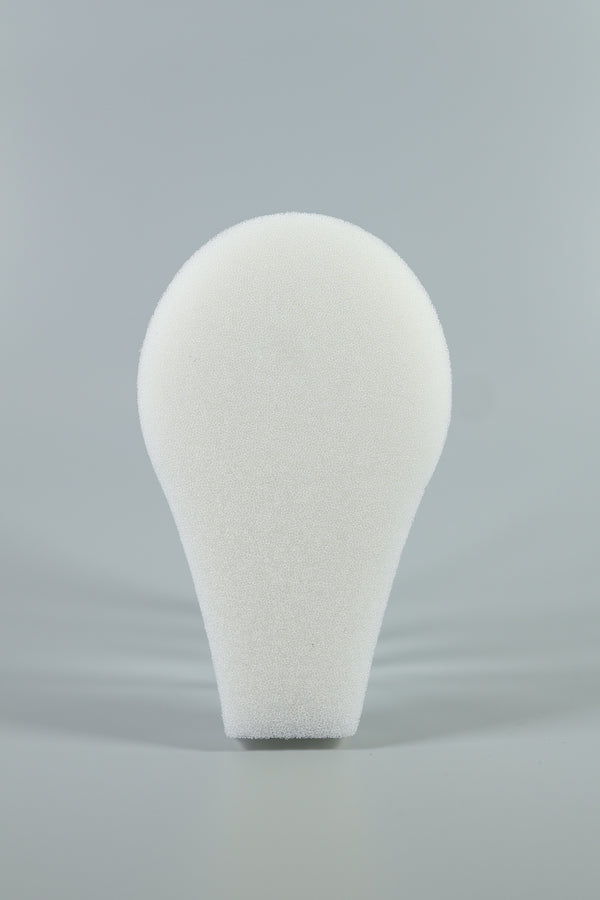 A white, teardrop-shaped C-Sponge II Surgical Throat Pack with integrated retrieval extension by Xemax is shown upright against a plain gray background.