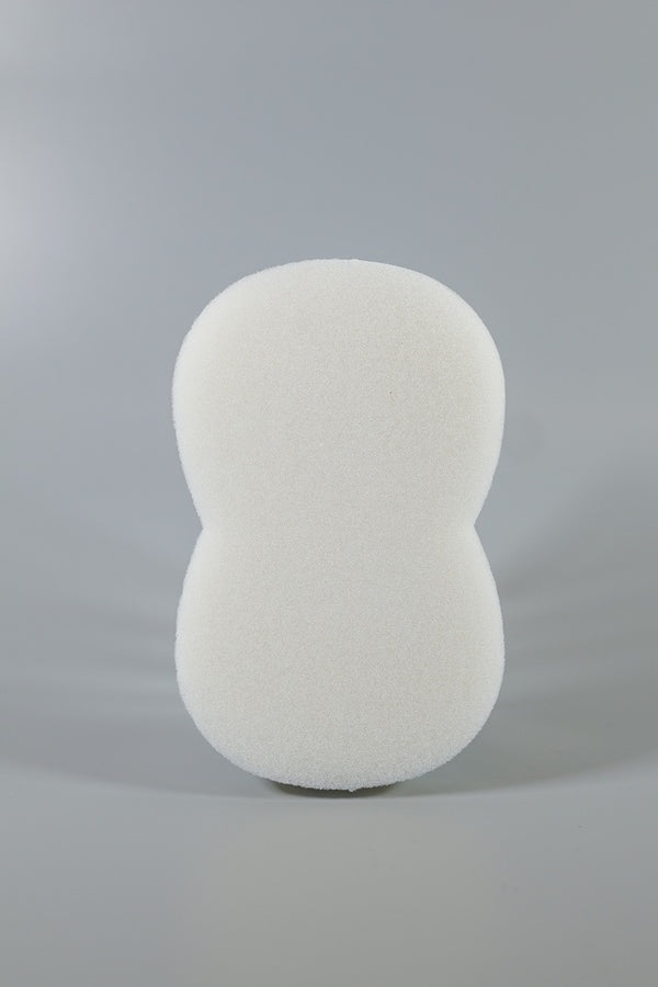 A large, peanut-shaped Xemax C-Sponge IV surgical throat pack (bag of 100) is shown upright against a plain gray background, designed for effective airway isolation.