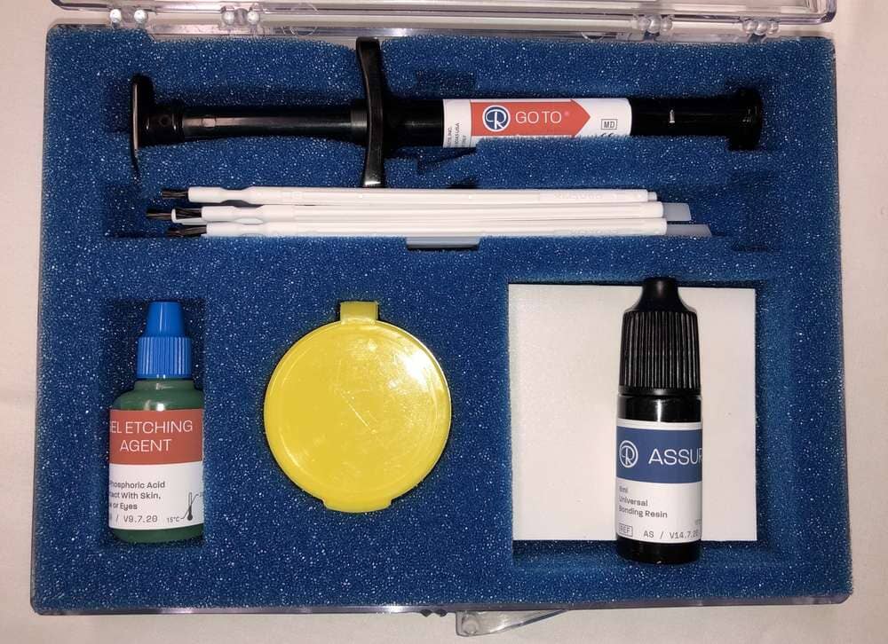 The Xemax Standard Light Cure Bonding Kit comes in a blue foam case and includes a syringe, small brush applicators, yellow container, and bottles labeled Etching Agent and Assure Bonding Resin—ideal for orthodontic bonding.