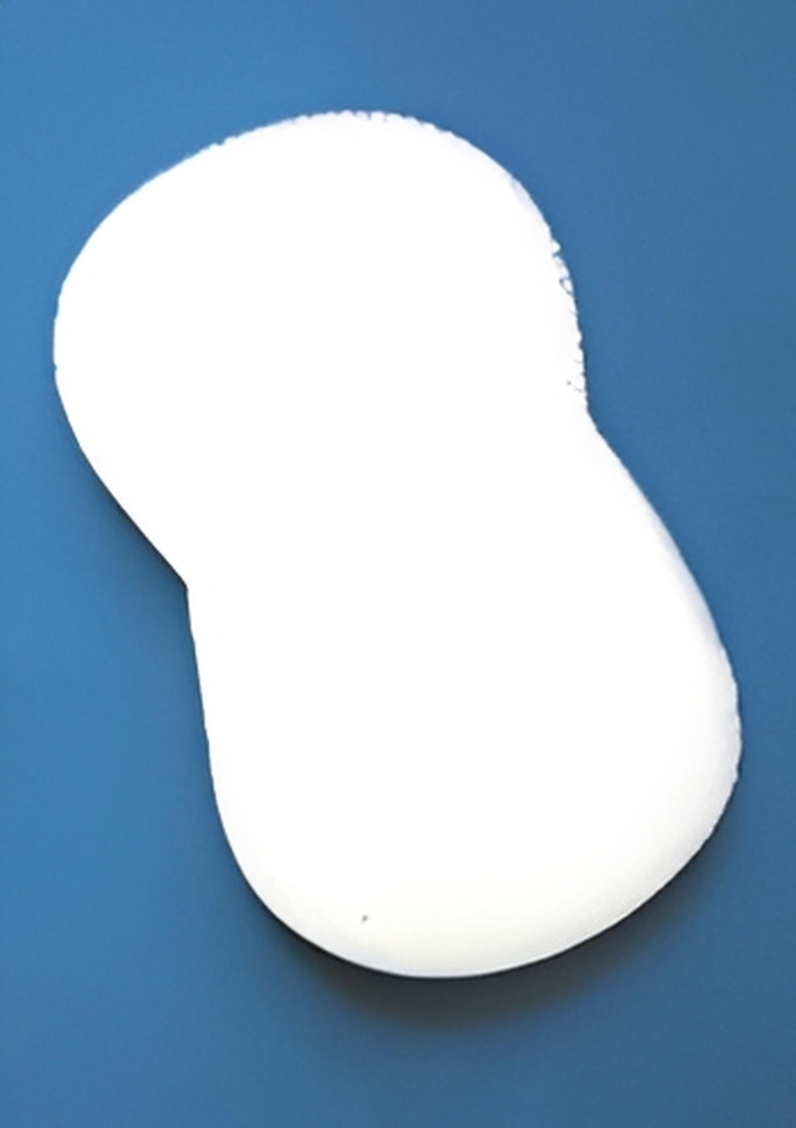 A large, white, peanut-shaped C-Sponge IV surgical throat pack by Xemax made of absorbent polyurethane foam rests against a solid blue background; available in bags of 100.