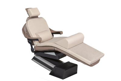 The Mediposture Dental Chair Overlay System with 4" iCore Memory Headrest by Mediposture is a modern beige dental or medical chair featuring adjustable headrest, armrests, footrest, and a memory foam pad for comfort, set against a plain white background.