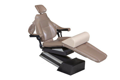 The Mediposture Dental Chair Knee Lift by Mediposture is a brown reclining dental chair with a headrest, padded leg support, and memory foam knee lift on a black base, delivering superior patient comfort; shown isolated on a white background.