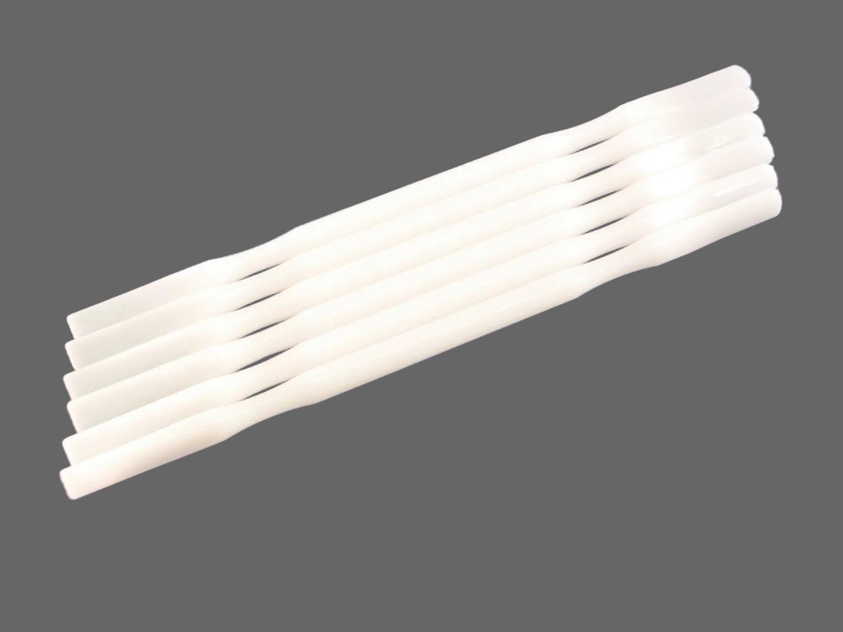 Reliance Nylon Mixing Spatulas are stacked together on a grey background