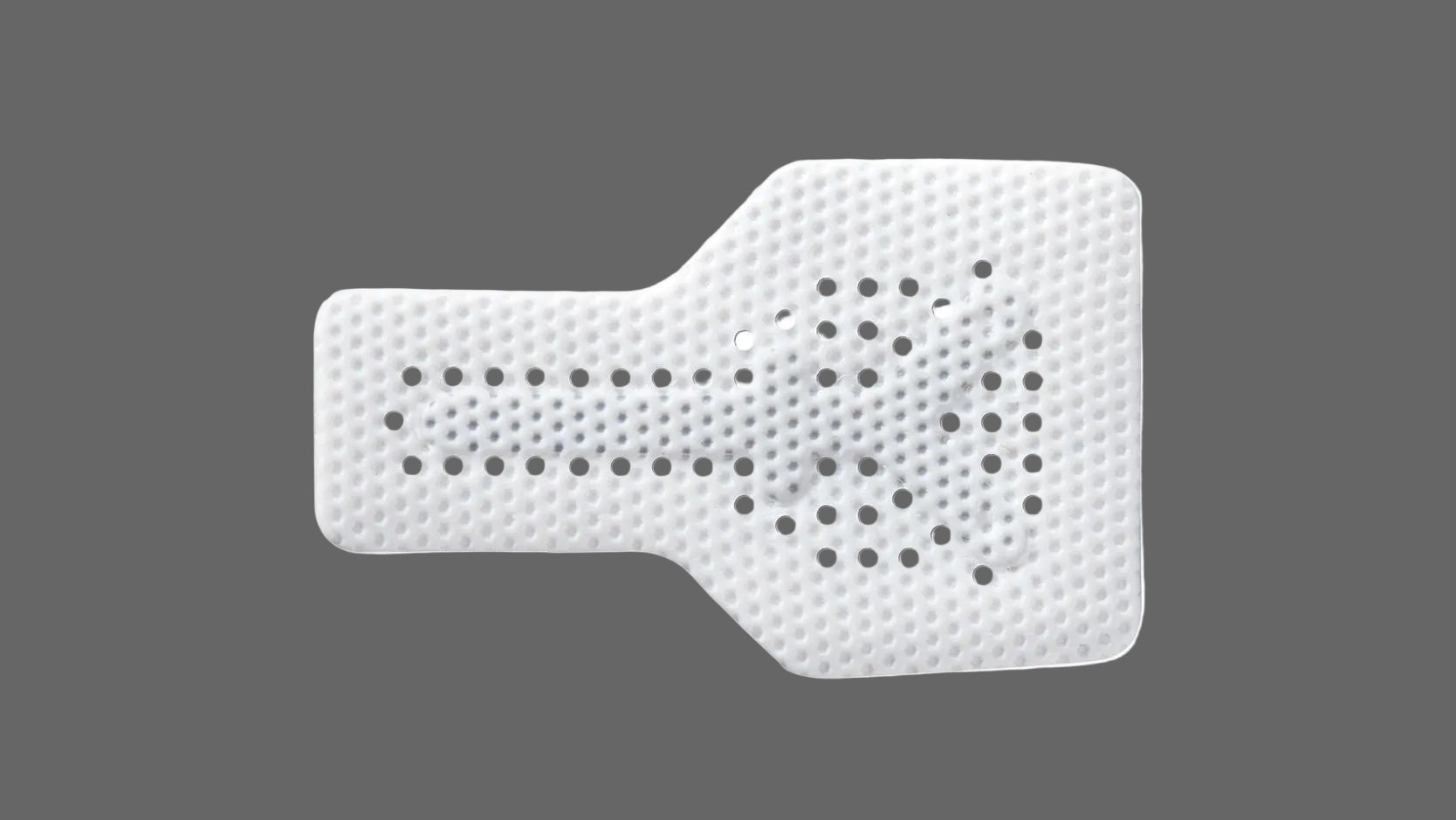 The Osteogenics RPM™ Reinforced PTFE Mesh Membrane (Box/1) is a white, perforated, guitar pick-shaped sheet with a rectangular extension for ridge augmentation, shown against a gray background.