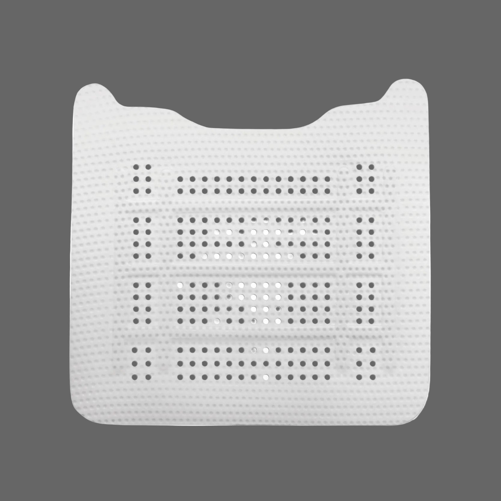The Osteogenics RPM™ Reinforced PTFE Mesh Membrane (Box/1) is a white perforated plastic sheet used in guided bone regeneration, resembling medical radiotherapy masks, as shown against a gray background.
