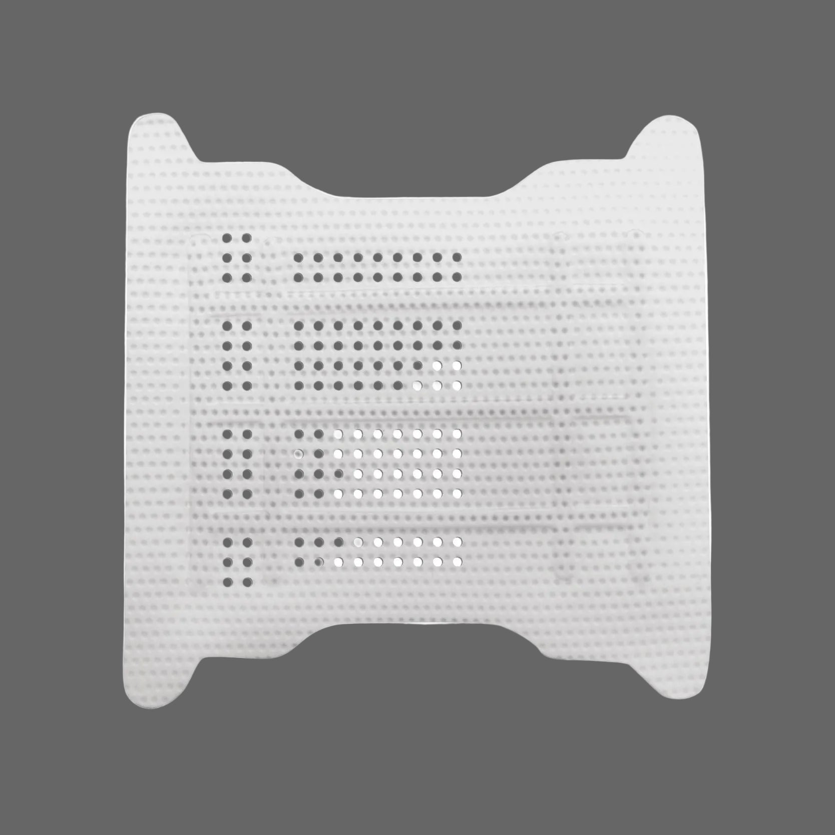 The Osteogenics RPM™ Reinforced PTFE Mesh Membrane (Box/1) is a white, rectangular membrane with rounded corners and multiple rows of perforations, designed for ridge augmentation, shown on a gray background.