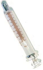 The Xemax Surgical Products Inc. Glass Irrigation Syringe - Autoclavable features a clear body, luer lock metal tip, brown measurement markings, and round plunger, displayed on a white background—resembling a classic 10cc glass syringe.
