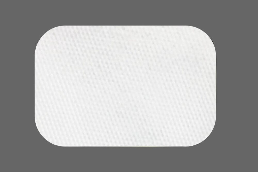 A white, rectangular ZMatrix™ Porcine Peritoneum Collagen Membrane by Osteogenics, featuring rounded corners and a subtle texture, is centered on a gray background, highlighting its suitability for ridge augmentation procedures.