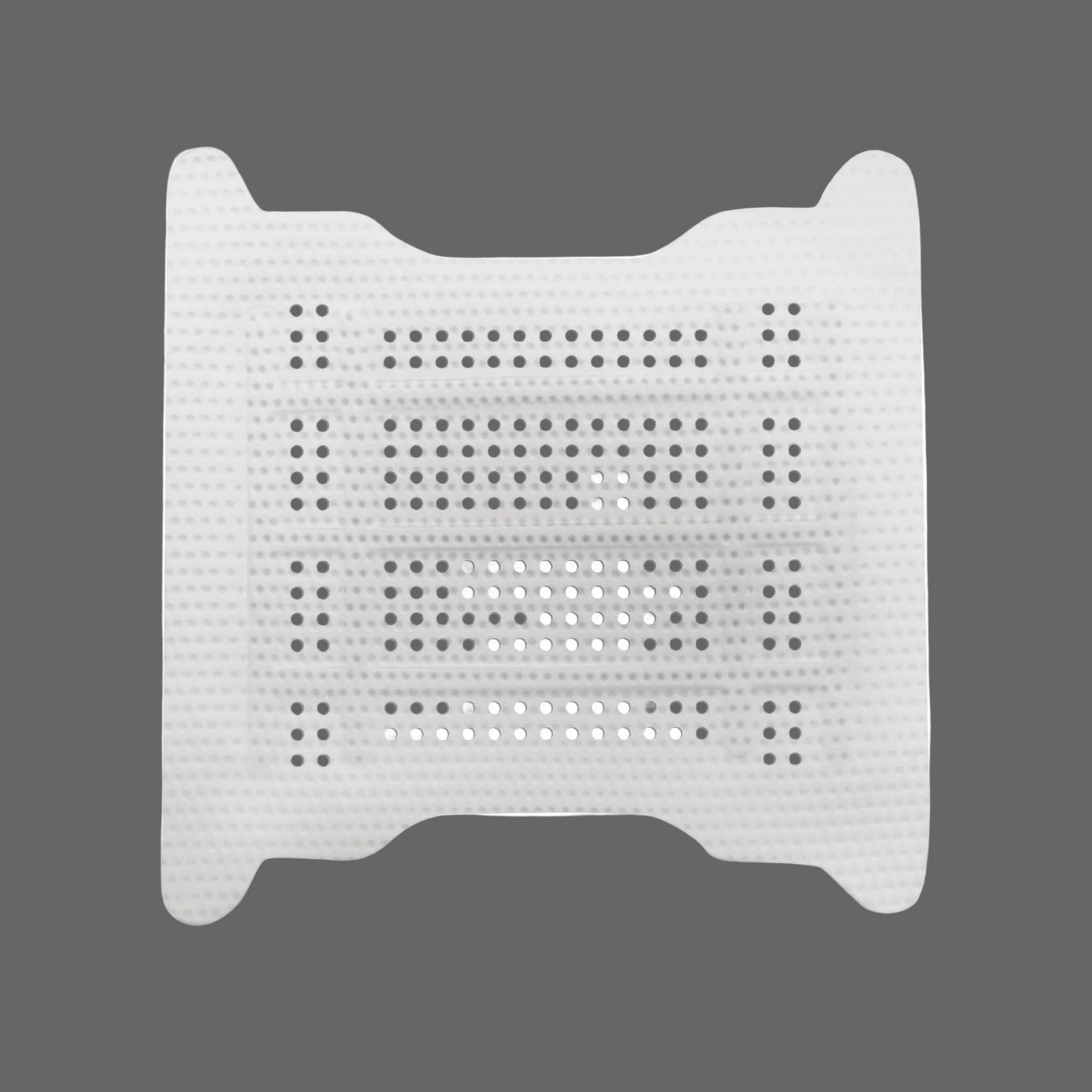 The Osteogenics RPM™ Reinforced PTFE Mesh Membrane (Box/1) is a white perforated membrane with multiple rows of small holes, ideal for ridge augmentation and guided bone regeneration, shown on a gray background.